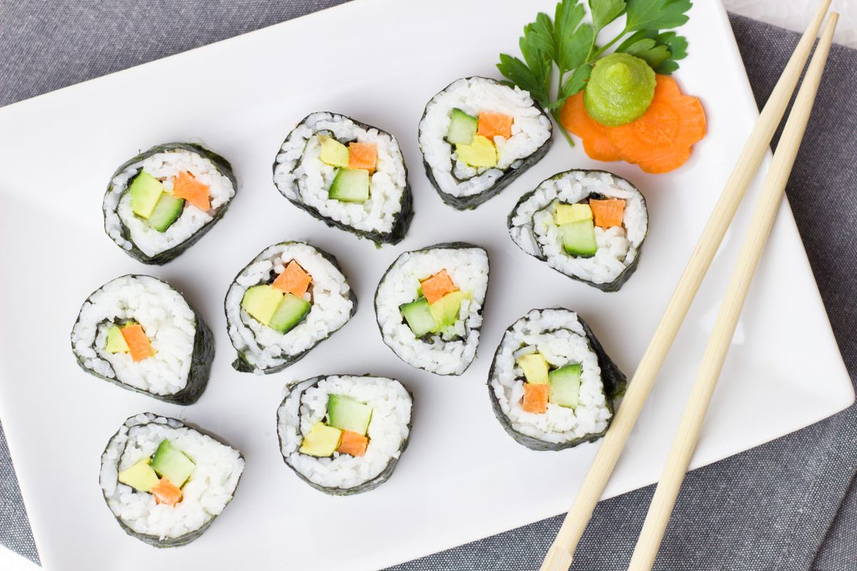Illustrative food photograph: cucumber and avocado sushi-style rolls